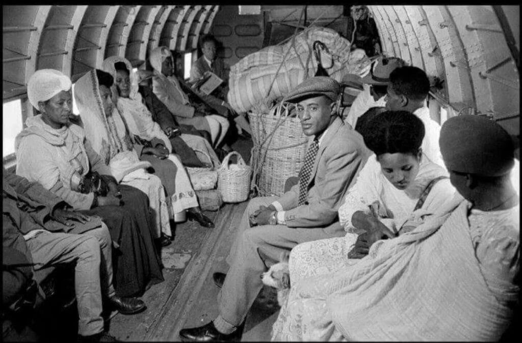 Passengers seated on canvas seats beside cargo inside Ethiopian Airlines’ first aircraft in 1946