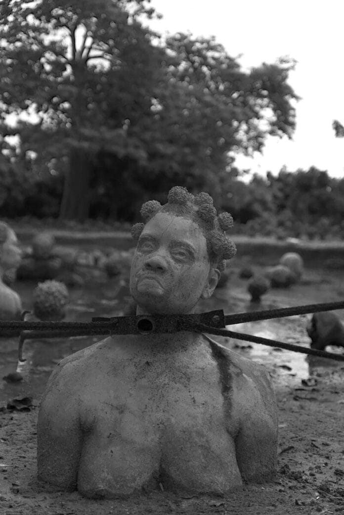 Sculpture of a woman's head and shoulders in mud