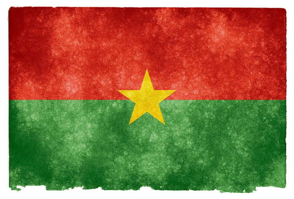 Grunge textured flag of Burkina Faso on vintage paper