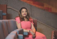 The Country Behind Billionaires, Global CEOs and Top Scientists — Despite an Economic Crisis Zimbabwe-born fintech entrepreneur Valerie Moran seated in an auditorium, wearing a coral-pink dress.